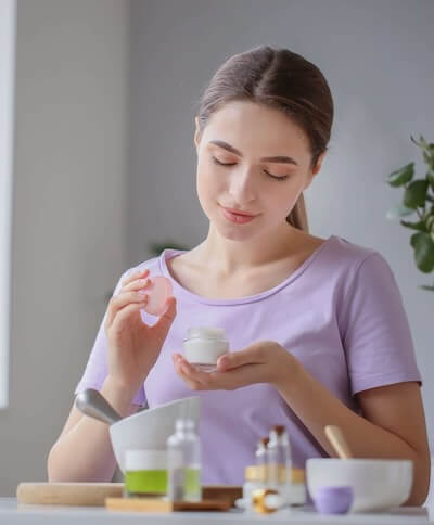 Woman blending aromatherapy recipes.