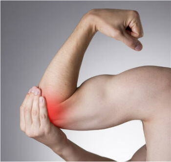 Man holding red spot around elbow indicating elbow pain.