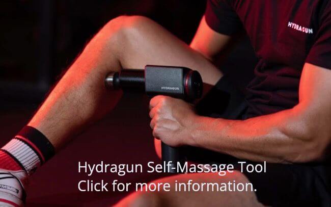 Hydragun self-massage tool being used on leg. Click to buy.